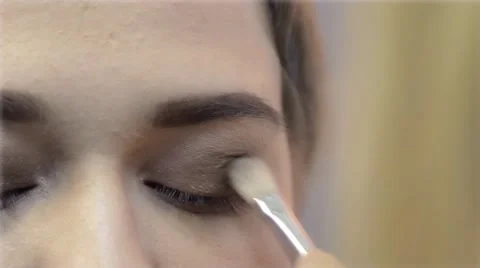 Make-up artist doing eye make-up for girl Video stock 58798704