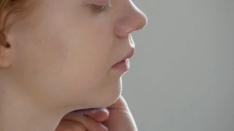 Make-up artist doing make-up of a beautiful young redhead girl, applies powder Stock Footage 73938779