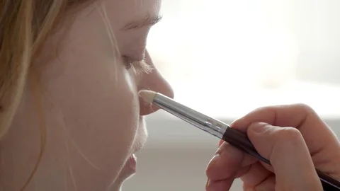 Make-up artist doing make-up of a beautiful young redhead girl, apply concealer  Stock Footage 73939103
