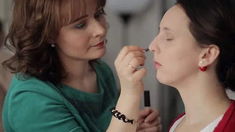 Make-up artist doing make-up for eyes and face models Stock Footage 73544698