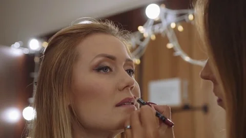 Make-up artist doing make-up lip pencil to stroke the lips.Makeup. Cosmetic Video stock 81048056