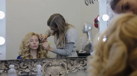 Make-up artist doing make-up model Stock Footage 61346895