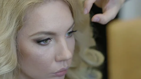 Make-up artist doing make-up model Stock Footage 64789229