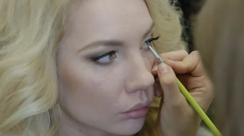 Make-up artist doing make-up model Stock Footage 67622275
