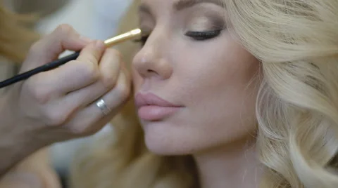 Make-up artist doing make-up model Stock Footage 68936546