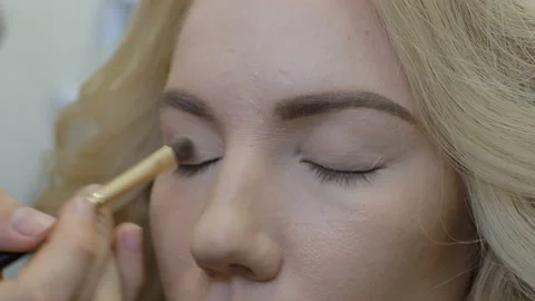Make-up artist doing make-up model Stock Footage 86733920