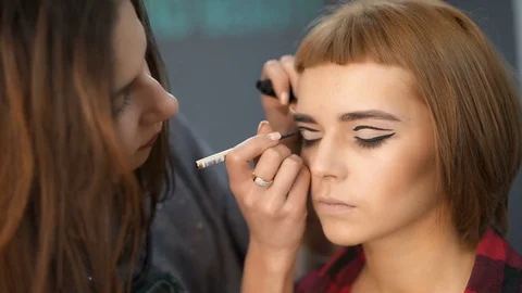 Make-up artist doing makeup. Female portrait. Close-up of hand near face. Stock Footage 83722762