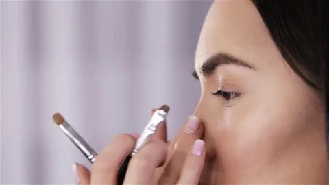 Make up artist doing professional make up of beautiful woman Video stock 70709696