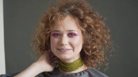 Make up artist doing professional make up of young woman Stock Footage 78999484