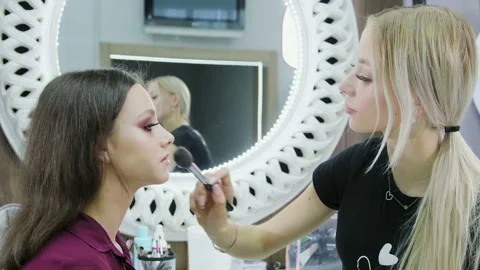 Make-up artist doing professional make-up young girl in a beauty salon Stock Footage 114159656