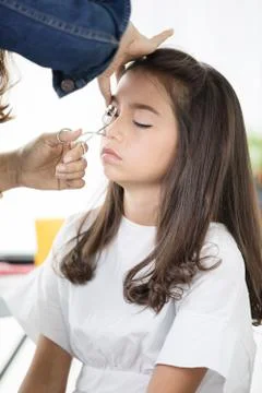 Make up artist doing professional make up of young asian cute girl Stock Photos