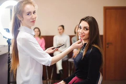 Make up artist doing professional make up of young woman. Foto stock