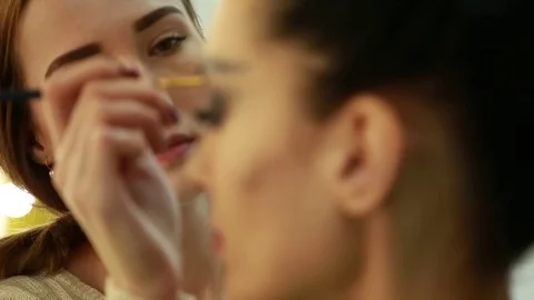 Make-up artist draws eyebrows Stock Footage 74349981