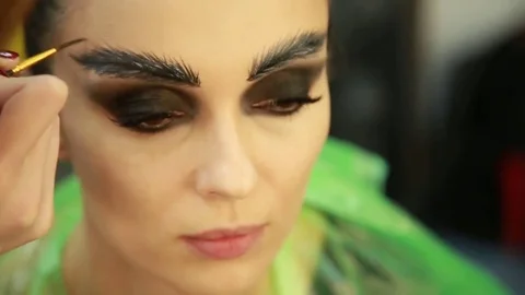 Make-up artist draws eyebrows Stock Footage 74350043