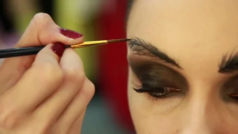 Make-up artist draws eyebrows Stock Footage 74350103