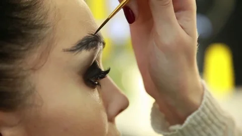 Make-up artist draws eyebrows Stock Footage 74350135