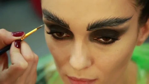 Make-up artist draws eyebrows Stock Footage 74350220