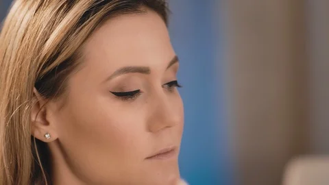 Make-up artist gently applies a dark white shade with a professional white brush Stock Footage 101096165