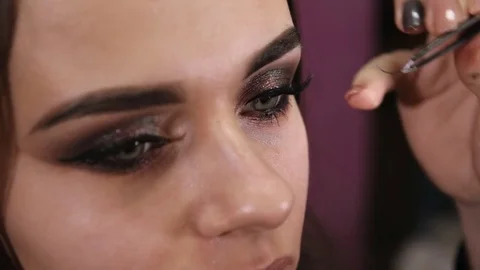 Make-up artist glues false eyelashes Stock Footage 84989017