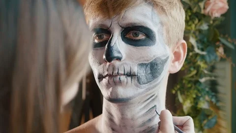 Make-up artist makes the guy halloween make up. Halloween male face art. Stock Footage 96483469