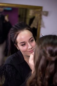 Make-up artist makes make-up an attractive model Stock Photos