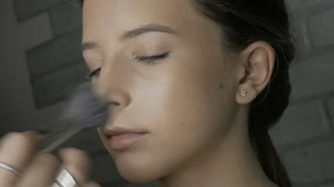 Make-up artist makes makeup to a young girl Stock Footage 102378809
