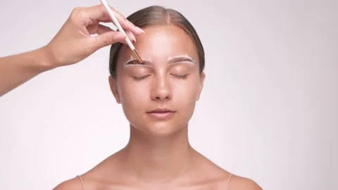 Make-up artist makes markings and dyes eyebrows. Stock Footage 157956978