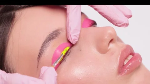 Make-up artist makes the procedure of lamination and dyeing of eyelashes Stock Footage 284949858