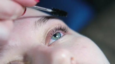 Make-up artist makes the procedure of lamination and dyeing of eyelashes to a Stock-Footage 291657177