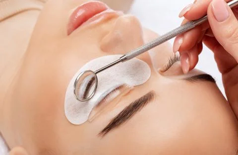 Make-up artist makes the procedure of lamination and dyeing of eyelashes to a Stock Photos
