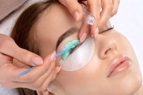 Make-up artist makes the procedure of lamination and dyeing of eyelashes to.. Stock Photos