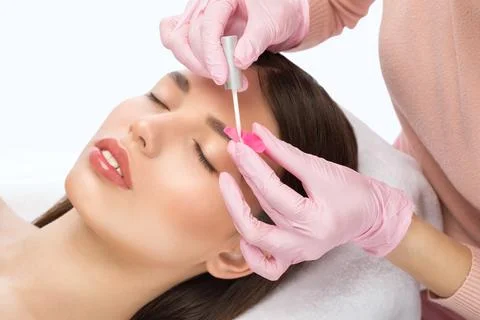 Make-up artist makes the procedure of lamination and dyeing of eyelashes to.. Stock Photos