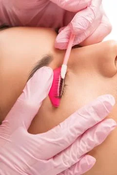 Make-up artist makes the procedure of lamination and dyeing of eyelashes to.. Stock Photos