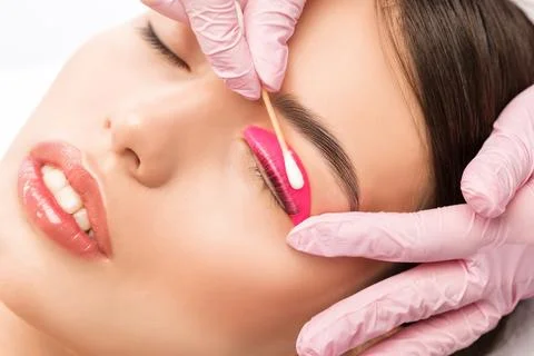 Make-up artist makes the procedure of lamination and dyeing of eyelashes to.. Stock Photos