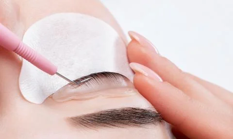Make-up artist makes the procedure of lamination and dyeing of eyelashes to.. Stock Photos