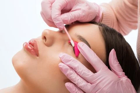 Make-up artist makes the procedure of lamination and dyeing of eyelashes Stock Photos