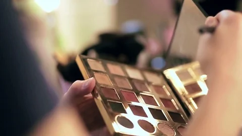 Make-up artist opens the palette of eye shadows, slow motion Stock Footage 76018655