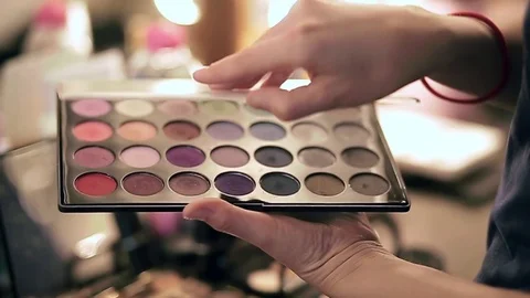 Make-up artist opens the palette of eye shadows, slow motion Stock Footage 76018659