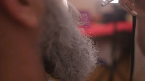 Make-up artist paints a man's beard Stock Footage 95653095