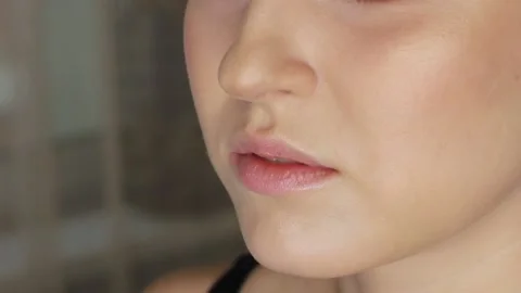Make-up artist paints model's lips Stock Footage 139503741