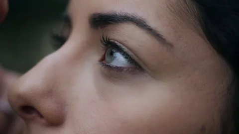 Make up artist passes the brush on the face of a young woman Stock Footage 74713319