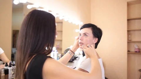 Make-up artist performs the procedure for cleaning the face of the girl Stock Footage 93339082