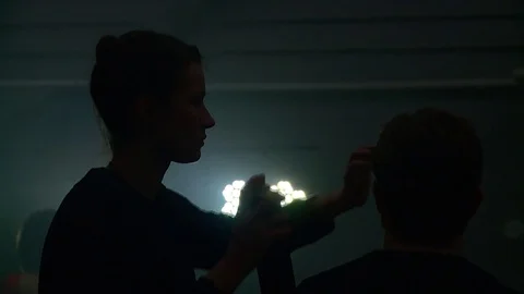 The make-up artist prepares the actor for the shooting. Take a music video. Stock Footage 84605523