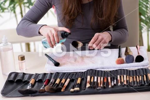 Make-up artist preparing brushes for work Stock Photos