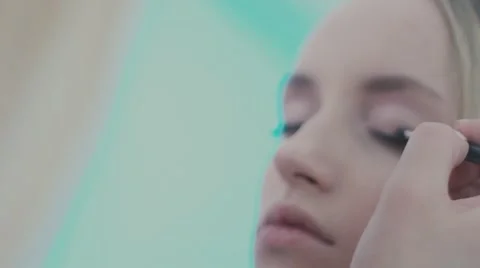 Make-up artist puts a brush for makeup to the eye model Video stock 68383959