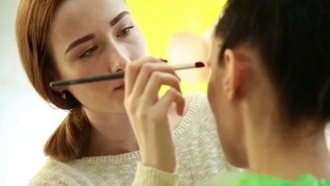 Make-up artist puts on make-up Stock Footage