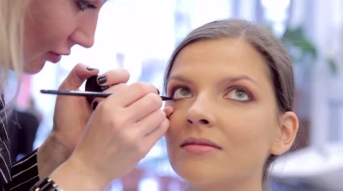 Make-up artist puts a makeup with eye-liner Stock Footage 68719284