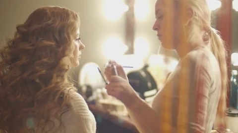 Make-up artist putting on make-up on model's eyes.
Eyelids make-up close up Stock Footage 75130385