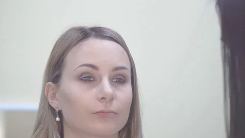 Make up artist putting on mascara on model's eyes. Eye make up Stock Footage 69924095