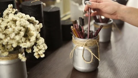 Make-up artist selects of the brush picks for applying makeup Stock Footage 99932554